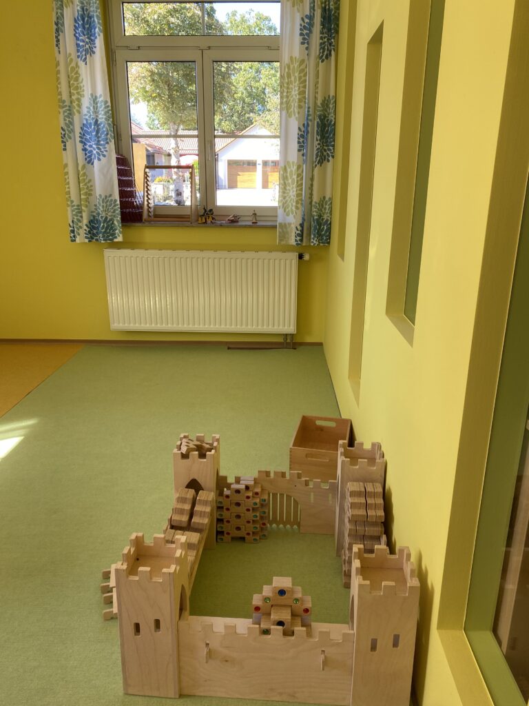 Ein Spielplatz mit Holzbau und Kisten.